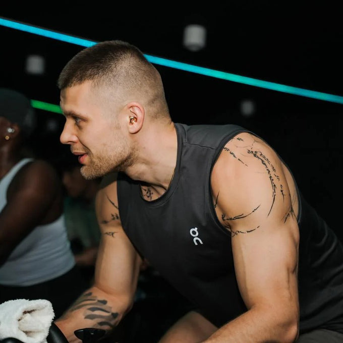 Man wearing Loop Switch 2 earplugs in a gym setting